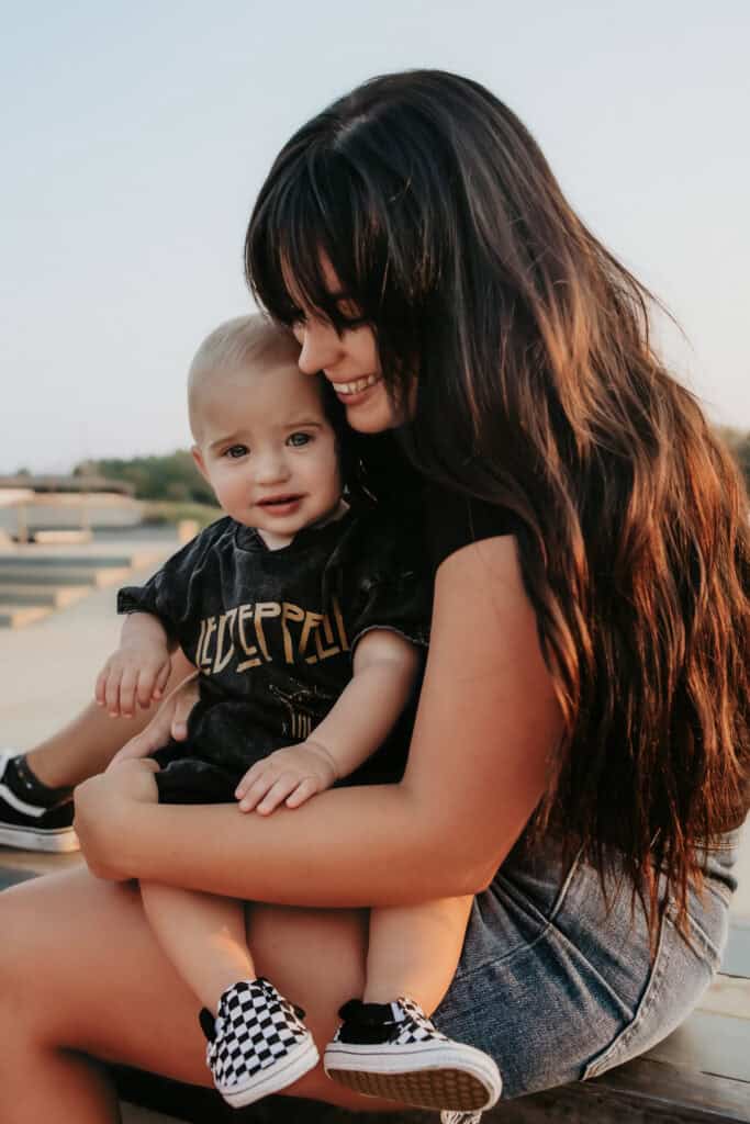 How to Choose a Family Photographer in Macon, GA 4 Mom holding her baby during a relaxed family photography session at a skate park in Macon GA