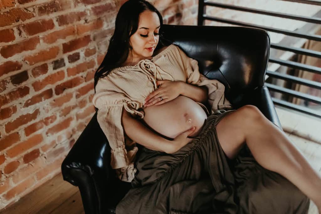 Midwives of Macon GA: Pregnancy, Birth & Women's Care Guide 2 Pregnant mother holding her belly during a maternity session in Macon GA near Midwives of Macon