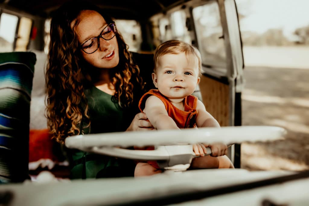 Mother and son sitting in a vintage VW Van driver seat
