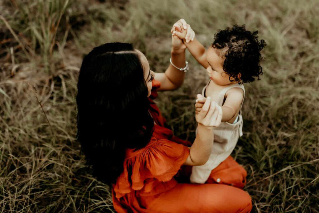Female OBGYN in Macon, GA: Local Doctors & Practices 3 Mother and toddler playing together in a grassy field during a Middle Georgia motherhood session.