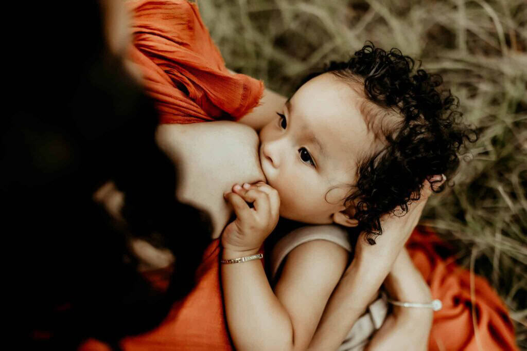 Female OBGYN in Macon, GA: Local Doctors & Practices 4 Close-up of a toddler nursing during an outdoor motherhood photography session.