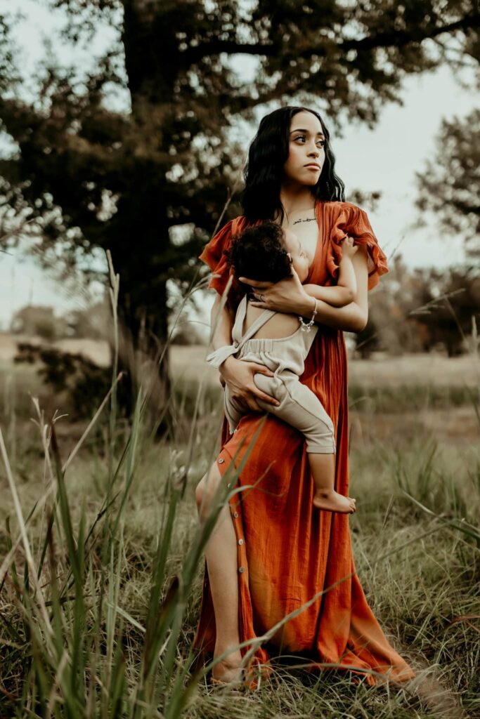Female OBGYN in Macon, GA: Local Doctors & Practices 7 Mother holding her toddler while standing in a field during a Middle Georgia motherhood session.
