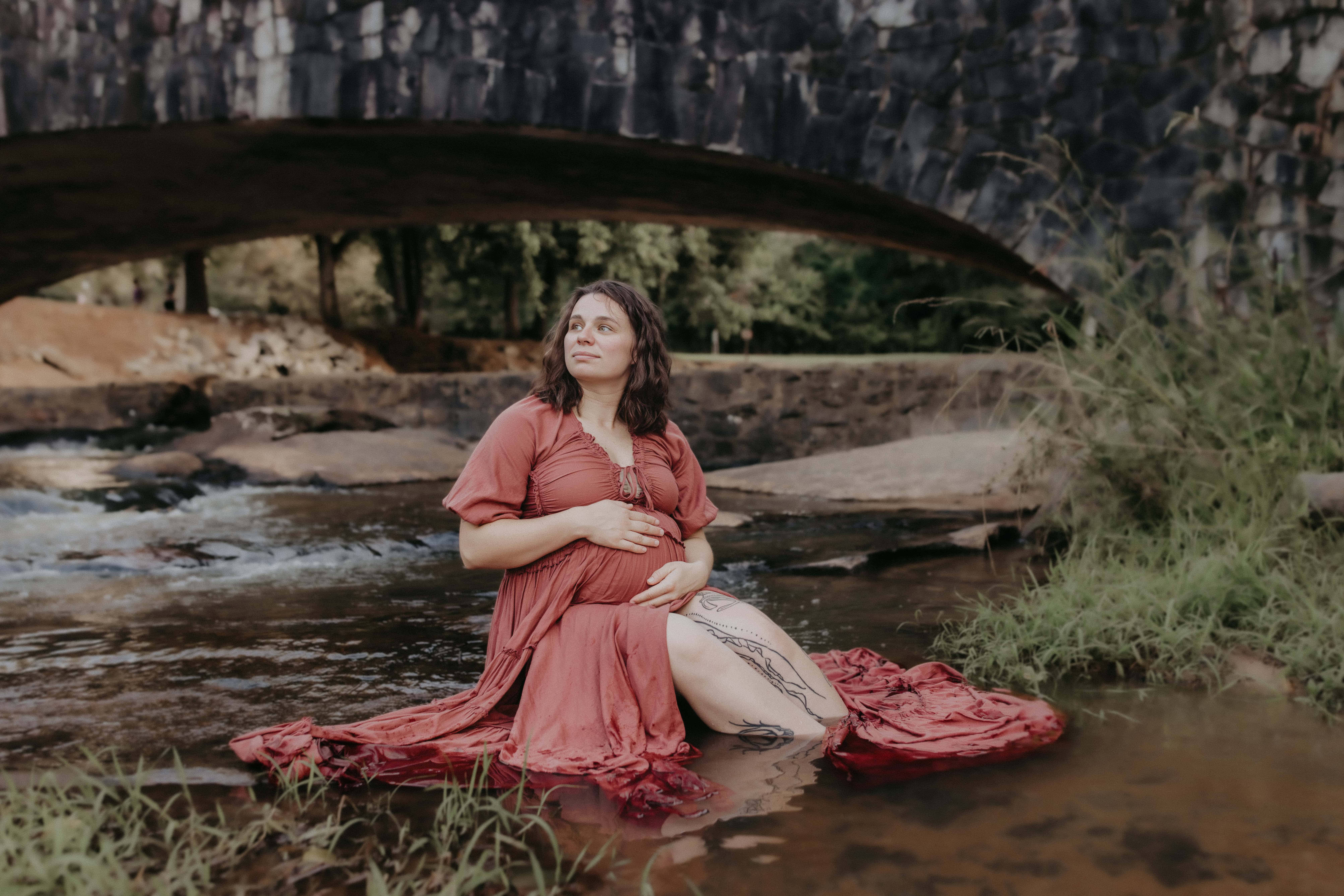 Expecting mother in Perry GA smiling softly during maternity session, photographed by Fire Family Photography.