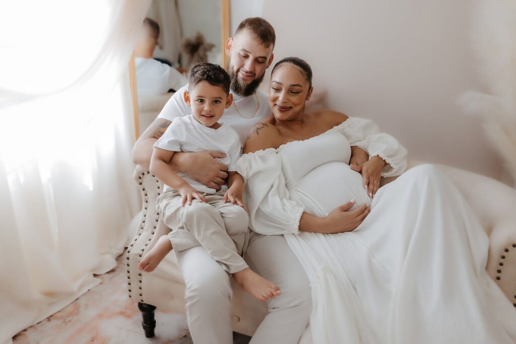 Maternity Session Prep Checklist: What to Wear, What to Bring, and How to Feel Ready 7 Family maternity photos in Macon GA with parents and little one on a cozy sofa