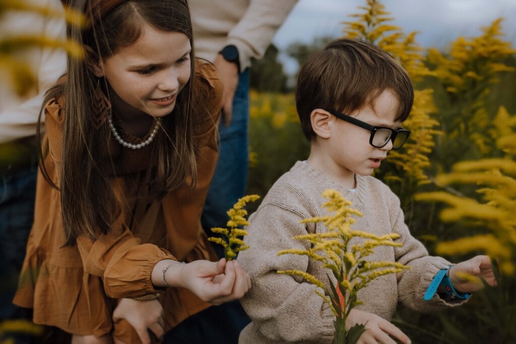 How to Prepare Your Kids for a Family Photo Session (Without the Pressure) 4 Child gently holding flowers during a family photo session, showing natural moments when preparing kids for family photos.