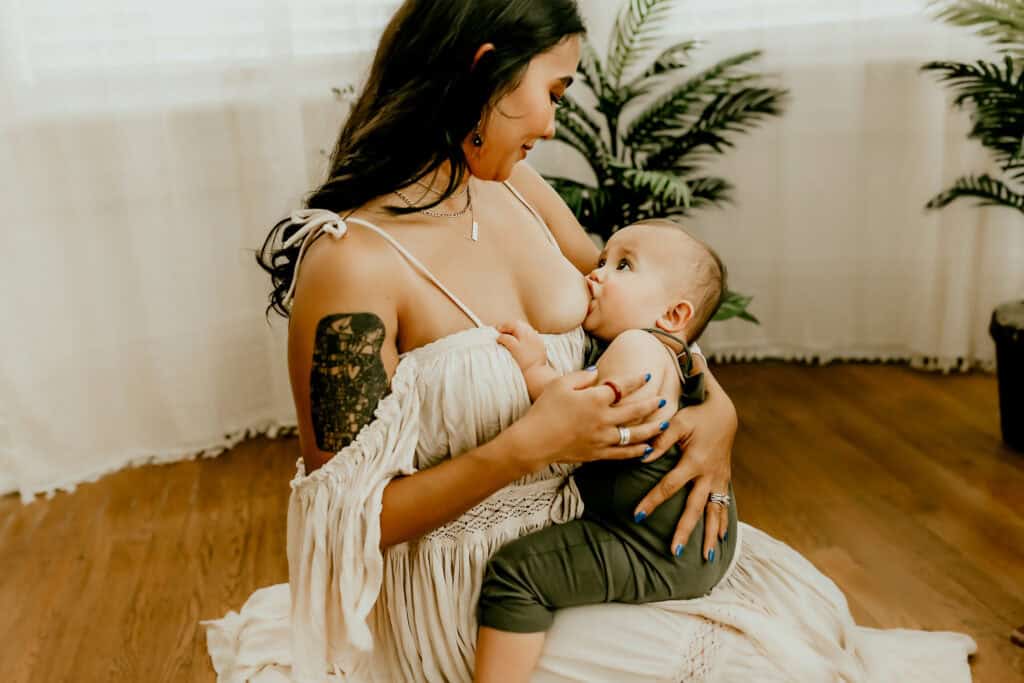 How I Photograph Mothers Who Don’t Love Being in Photos 5 Mother breastfeeding her baby during an intimate motherhood photography session in Middle Georgia, focused on connection and comfort.