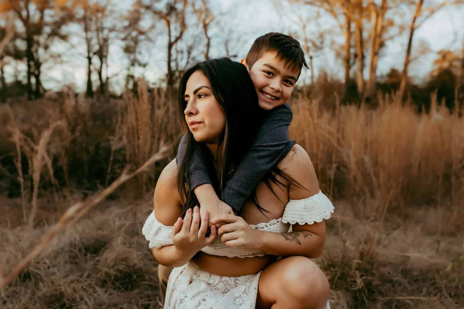 How I Photograph Mothers Who Don’t Love Being in Photos 3 Mother and son sharing a playful moment during an outdoor family photography session near Warner Robins, GA.