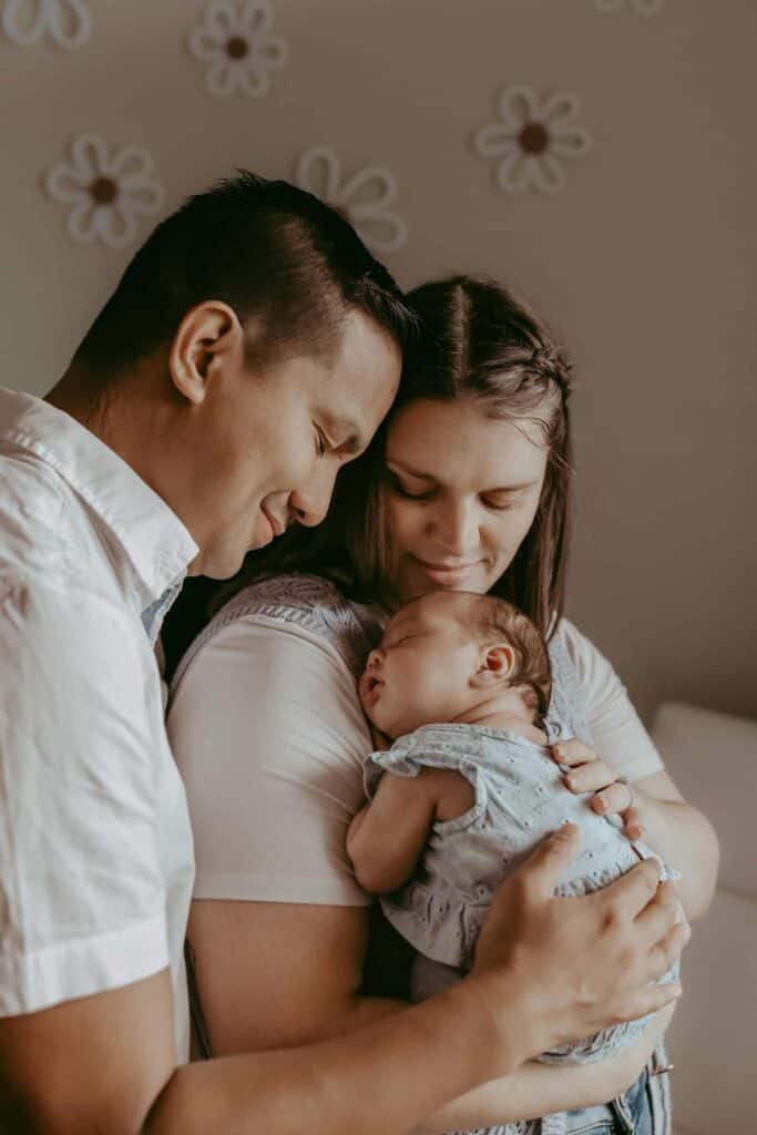 Do Newborn Photos Have to Happen in the First Two Weeks? 4 Parents holding their sleeping newborn during an in-home newborn session in Middle Georgia.
