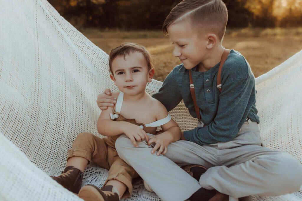 Two brothers sitting together during a relaxed fall family photography session