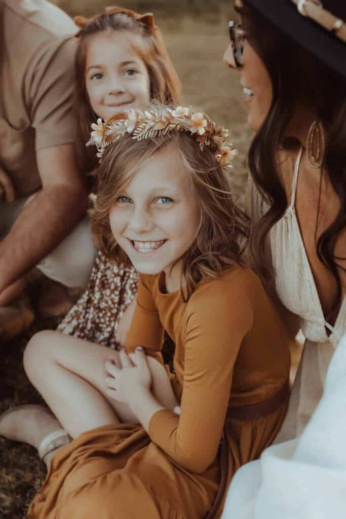 Mom and daughters sitting together during a fall family photography session