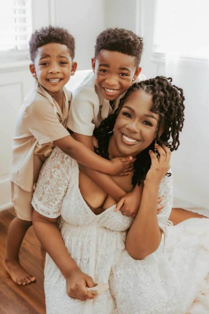 Children’s Boutiques & Consignment Shops Near Warner Robins GA 3 Mother smiling with her two sons during an indoor family photography session in Middle Georgia.